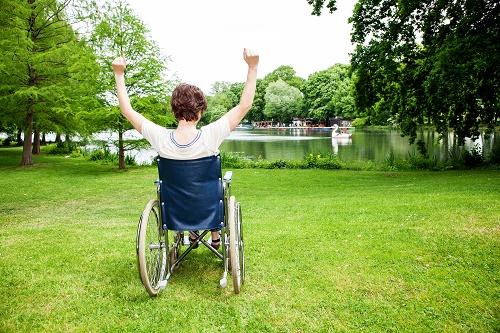 Young person in wheelchair cheering
