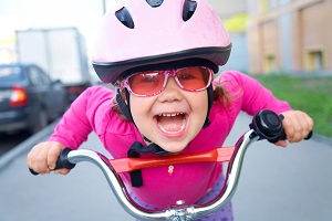 Young girl on bike looking at camera