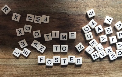Scrabble tiles spelling time to foster