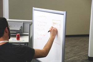 Trainer writing on a whiteboard
