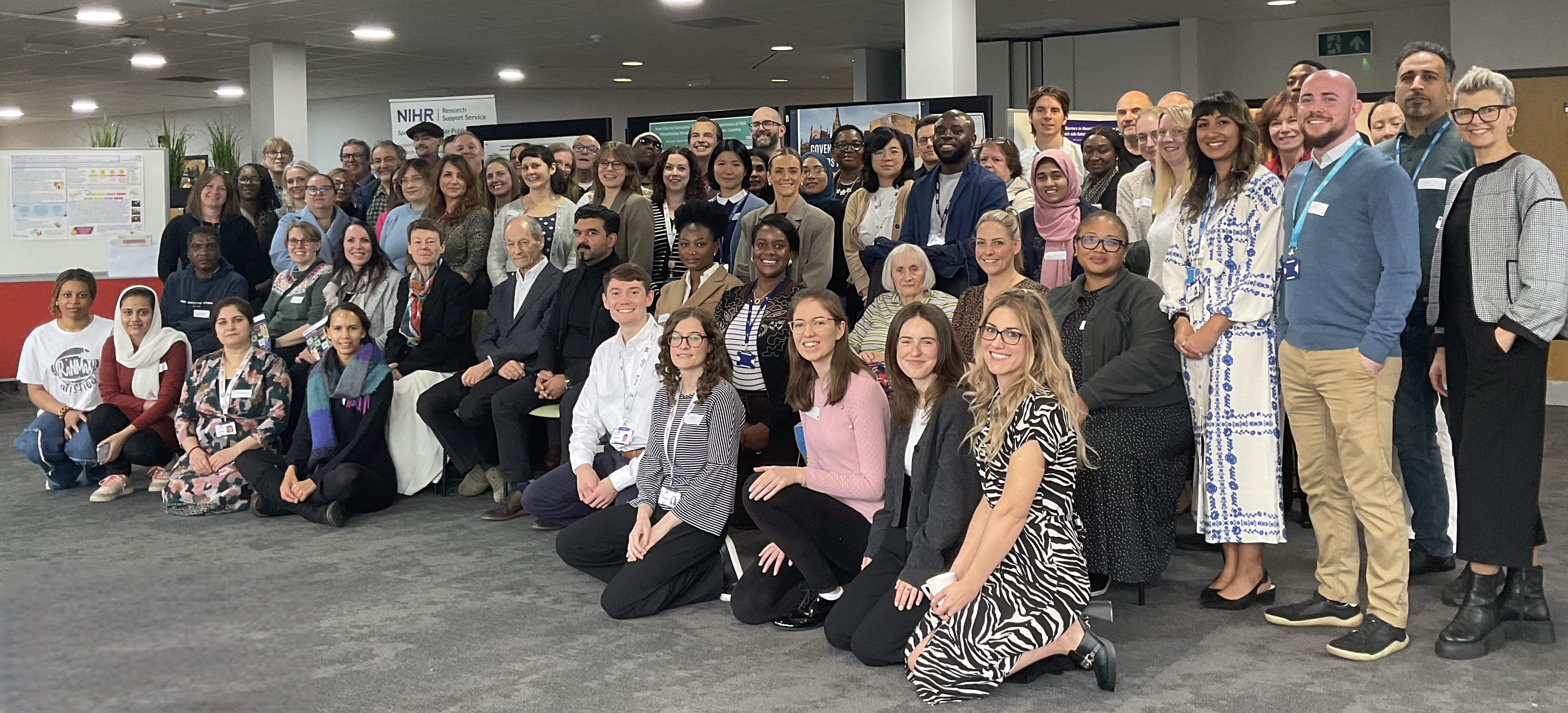 A diverse group of people smiling at the camera.