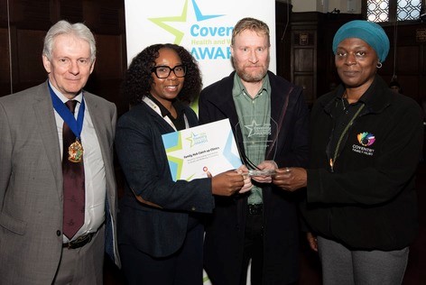 The Hub Catch Up Clinic Service members and a member of Coventry Council posing for the Coventry Health and Wellbeing Award