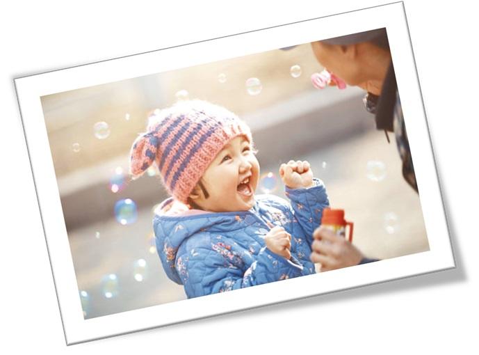 Young girl playing with bubbles