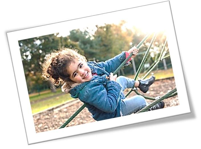 Young girl plays on climbing frame